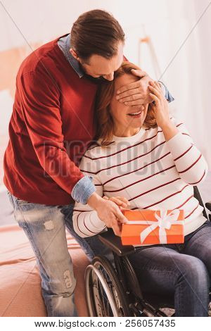 Cheerful Mid Aged Man Making A Present