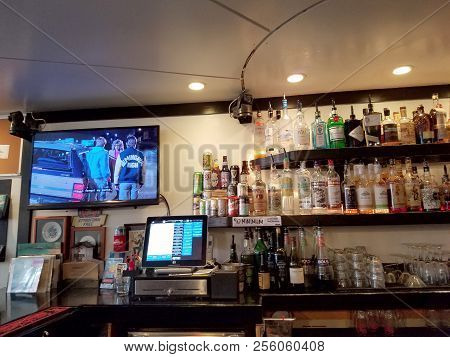 Honolulu - August 6, 2017: Movie Plays On Tv Inside Local Downbeat Diner Bar With Liquor On Display 