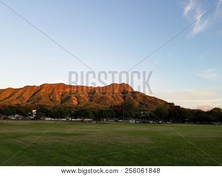 Kapiolani Park At Dusk With Diamond Head And Clouds In The Distance On Oahu, Hawaii.