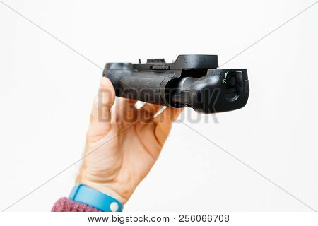 Photographer Hand Holding Against White Background A Battery Camera Grip For His New Camera