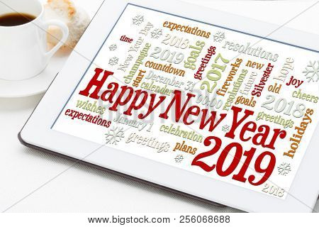Happy New Year 2019 greetings card  - word cloud on a digital tablet with a cup of coffee