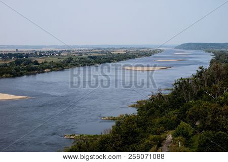 A Large River In Central Europe With A Sandy Island. A Sandstorm In The Middle Of A Large River.