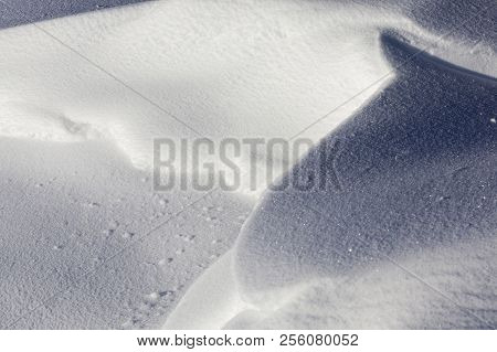 Snow Drifted Into Big Snowdrifts On The Rest Of The Flat, Snow-covered Surface, Closeup
