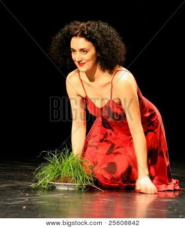 nainen tanssija ja esiintyjä polvillaan punainen aikana pina bausch
