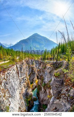 Waters From Tokuum Creek Below The Deep And Narrow Marble Canyon With Vermilion Peak In The Backgrou