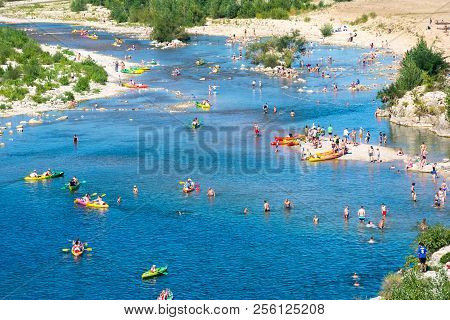 Remoulins,france-august 12, 2016:people Swim And Canoe Near The Pont Du Gard Roman Aqueduct During A