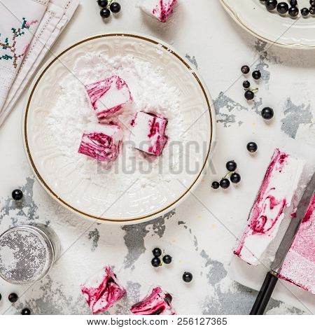 Blackcurrant Swirl Marshmallow In A Plate With Icing Sugar, Square