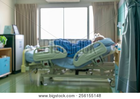 Blurred Image Of A Man Patient Sleeping In Hospital Bed