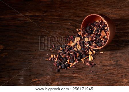 Fruit Tea In A Clay Bowl On A Wooden Table And Black Background. Selective Focus