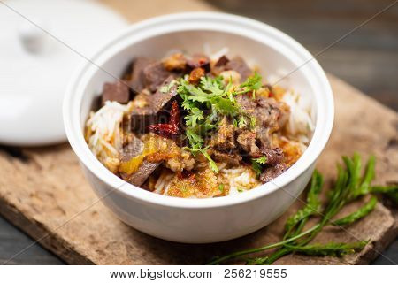Northern Thai Food (kanom Jeen Nam Ngeaw) In A Bowl With Vegetables On Wooden Table, Spicy Rice Nood