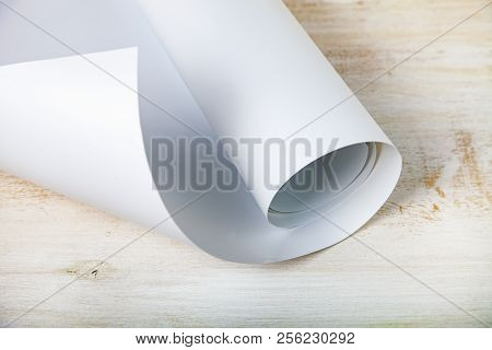 Roll Of White Paper On A Wooden Background.