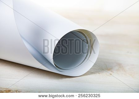 Roll Of White Paper On A Wooden Background.