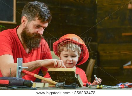Boy, Child Busy In Protective Helmet Learning To Hammering Hobnails With Dad. Masculine Duties Conce
