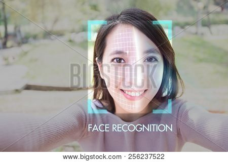 Young Woman Is Taking Selfie For Facial Recognition Concept