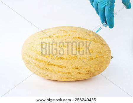 Melon On A White Background In Which Enter Gmo And Nitrates, Close-up, Genetically Modified Organism