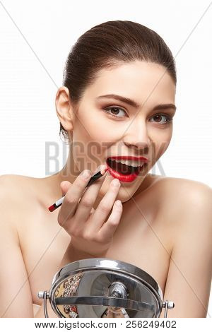 Girl Applying Red Lipstick Isolated On White
