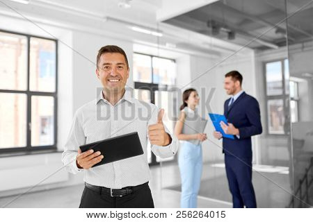 real estate business, sale and people concept - happy smiling realtor or businessman with tablet pc computer and customers at new office room