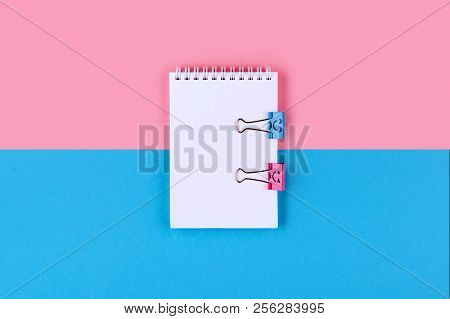 Top View Of Blank Notebook On Colorful Background Pink Blue With Copy Space.