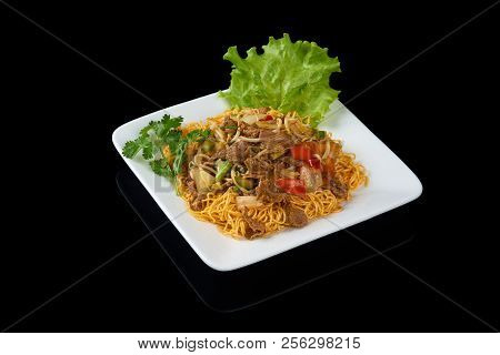 Mi Xao Stir-fried Noodles Asian Meals On Triangle Plate Isolated On Black