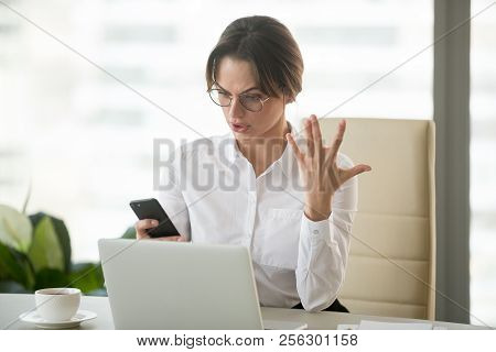 Angry Businesswoman Annoyed With Stuck Not Working Phone In Offi