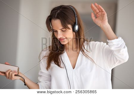 Woman Holding Phone Dancing Listening To Music Playing In Headph
