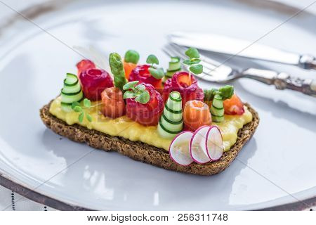 Danish Smorrebrod With Gravlax And Omelet On Rye Bread
