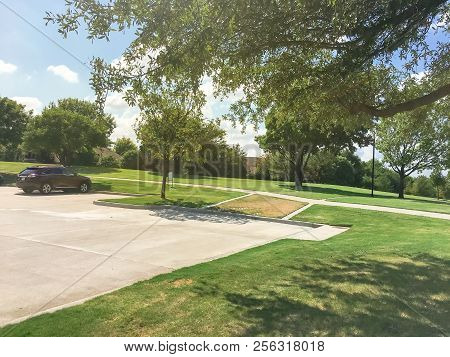 Green Park With Pathway From Shady Parking Lots In Coppell, Texas, Usa