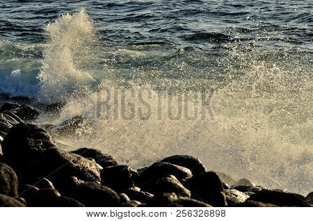 Waves Crashing On Rocks In The Galapagos Islands