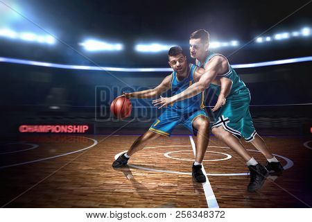 Two Basketball Players During Scrimmage On Indoor Basketball Court