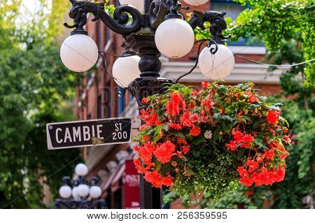Cambie Street Light And Sign With Hanging Flower Basket In The Heart Gastown, Touristy Heritage Dist