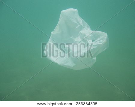 Plastic Bag Floating Into The Sea. Polluted Enviromental. Recycle Garbage
