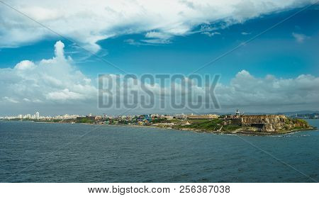 Scenic View Of Historic Colorful Puerto Rico City In Distance With Fort In Foreground
