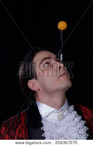 The Juggler Have A Balanse Ball On The Spoon