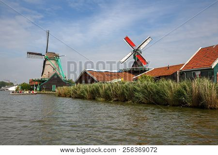 Zaanse Schans, Netherlands, August 19, 2015 - Traditional, Authentic Dutch Windmills At The River Za
