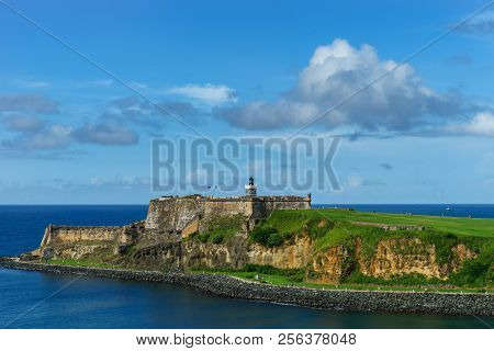 Scenic View Of Historic Colorful Puerto Rico City In Distance With Fort In Foreground From The Sea C