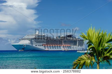 Cruise Ship In Crystal Blue Water With A Palm On The Front