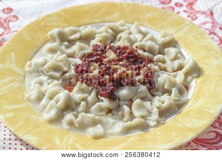 Close-up Angled Shoot For Traditional Taste Turkish Ravioli With Yellow Banded Plate With Tomato Sau