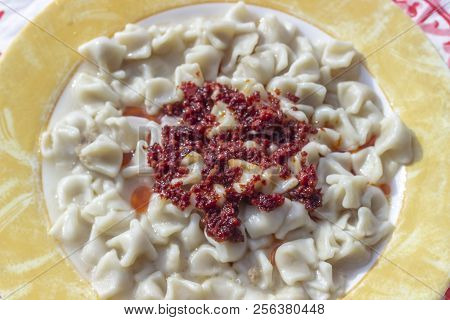 Close-up Shoot For Traditional Taste Turkish Ravioli With Yellow Banded Plate With Tomato Sauce
