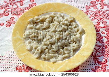 Close-up Top Shoot For Traditional Taste Turkish Ravioli With Yellow Banded Plate