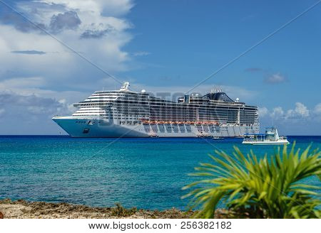 Cruise Ship In Crystal Blue Water With A Palm On The Front