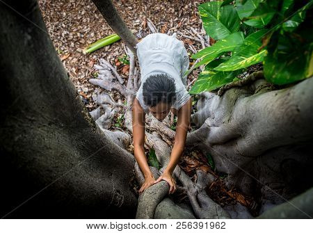 A Beautiful African-looking Girl With Black Short Hair And White Dress Pousing Near The Big Beautifu