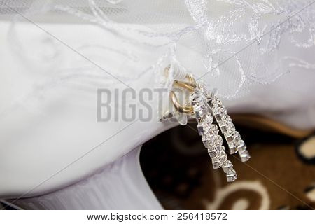A Wedding Gentle Bouquet Of White And Pink Roses And High-heeled Shoes On A Green Grass In The Park.