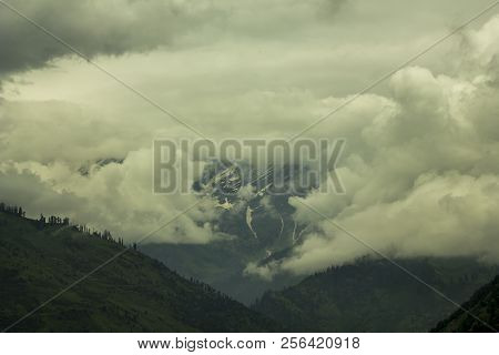 Heavy Cloud In The Snow And Green Mountain Valley