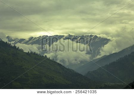 Heavy Dark Sky On The Hills And Snow Top Mountains