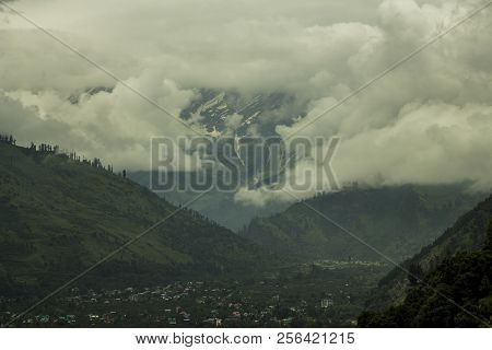 Vallage In The Mountain Valley With Heavy Cloud