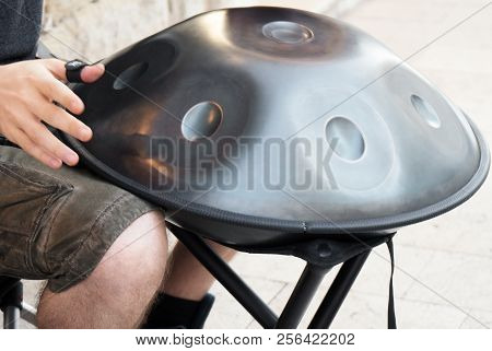 Unrecognized Man On The Street Playing Hang.