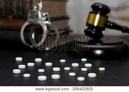 Judge's Gavel With Handcuffs, Drugs On Wooden Table