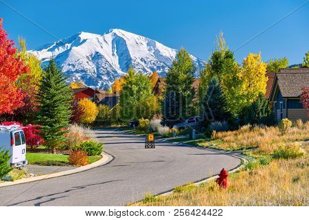 Slow children at play street sign at residential neighborhood in Colorado at autumn, USA. Mount Sopris landscape.