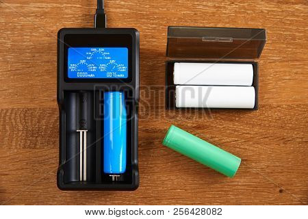 18650 Li-ion Battery Charging By Premium Charger  On A Table