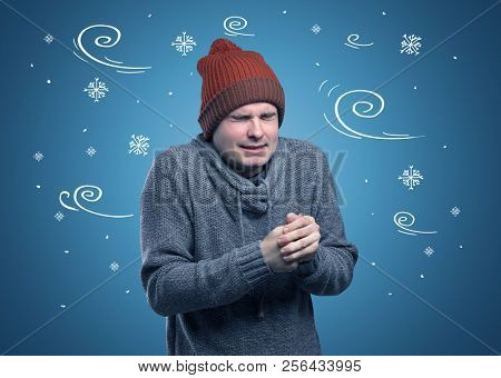 Young hipster frozen boy with doodled snowflakes and windy concept